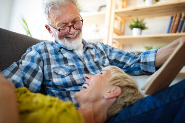 Happy senior couple in love hugging and bonding with true emotions at home