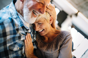 Happy senior couple in love hugging and bonding with true emotions at home - obrazy, fototapety, plakaty