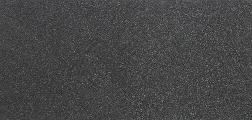 Texture of black foam rubber and background, close-up. Panorama. Piece of black sponge foam.