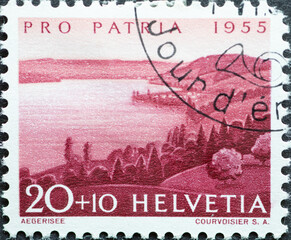 Switzerland - Circa 1955 : a postage stamp printed in the swiss showing a landscape with mountains and Aegeri lake, national celebration Pro Patria