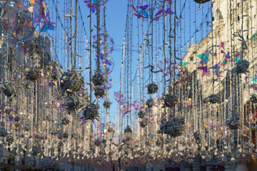 Famous pedestrian touristic Nikolskaya street during coronavirus pandemic time. View at the sky, festive decoration and facades of houses.