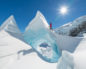 Man in red Ice climbing on The Tasman Glacier (Haupapa) which is the largest glacier in the...