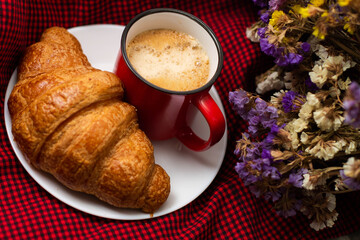 Naklejka na ściany i meble french breakfast coffee with croissant and flowers on a beautiful background