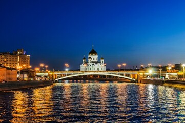 Fototapeta na wymiar View of the Big Stone Bridge and the Cathedral of Christ the Savior in the late evening in August from the Moscow River. Moscow, Russia.