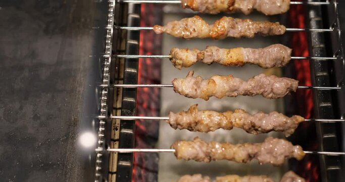 mutton kebabs on grill machine. Traditional Chinese food