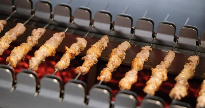 mutton kebabs on grill machine. Traditional Chinese food