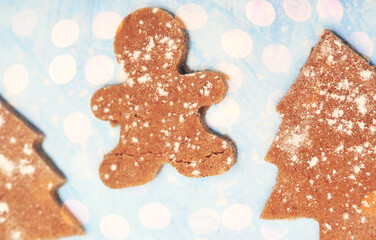 Christmas cookies  on blue background with lights.
