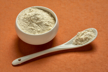 a small bowl and teaspoon of yacon root powder,  a powerful prebiotic sweetener derived from the yacon tuber
