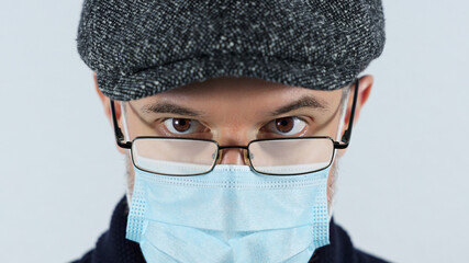 Man with foggy glasses caused by wearing a covid protective mask