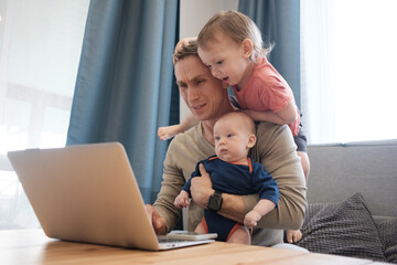 Busy man trying to work while babysitting kid