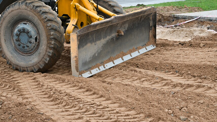 Bulldozer levels the ground for the road