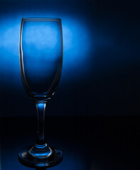 a glass of white wine. empty glass on a dark blue background. copy space