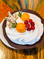 Christmas delicious cakes decorated with a gingerbread snowflake, cranberries, physalis.