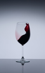 glass of splashing red wine
