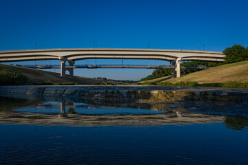 Bridge and blue sky reflecting in the river