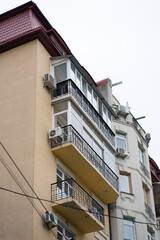 Fototapeta na wymiar Building. Balconies. Air conditioners on the balcony of a residential building. Problems of modern architecture.