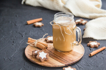 Pumpkin spiced latte or coffee in a cup on turquoise vintage background. Autumn, fall, or winter hot drink. Cozy breakfast or snack.