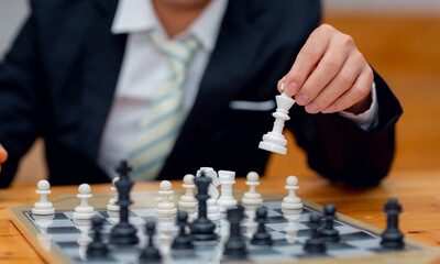 Businessman playing chess on board in office, strategy and competition Chess financial business...