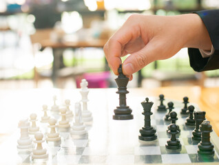 Businessman playing chess on board in office, strategy and competition Chess financial business...