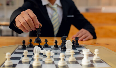 Businessman playing chess on board in office, strategy and competition Chess financial business...