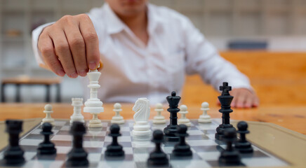 Businessman playing chess on board in office, strategy and competition Chess financial business...