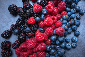 berries mix on an abstract gray background, seen from above