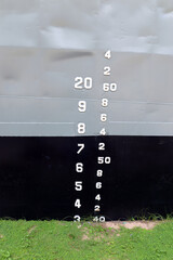 The numbers tell the depth of the water. On the side of the ship