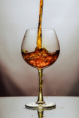 Alcoho in translucent glass on white background.