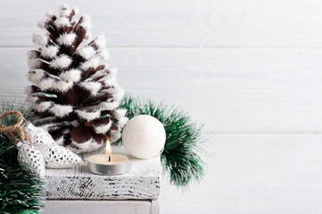 Christmas decoration with pine cone and lit candle