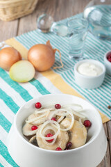 plate with mushrooms and onion rings with berries on wooden background, close view 