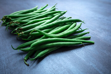 Green beans on gray stone background