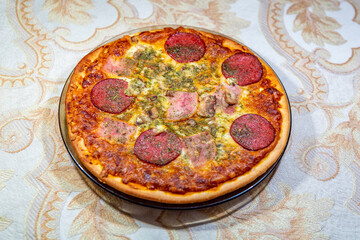 Textured surface of cheese pizza with spices. Homemade fresh baking recipe