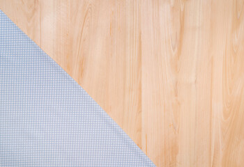 Top view of hand towel and wooden texture background