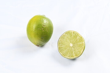 Sliced, bright green lime on a high-key background.