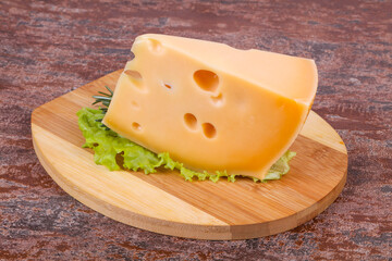Maasdam cheese  in the board served salad leaves