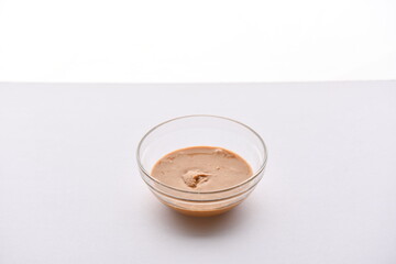 Superfood, vegan ingredients photographed on a high-key background, include bananas, blueberries, kale, soy milk, flaxseed milk, peanut butter, pumpkin seeds and salt.