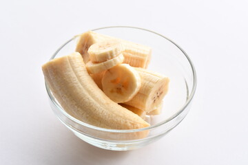 Superfood, vegan ingredients photographed on a high-key background, include bananas, blueberries, kale, soy milk, flaxseed milk, peanut butter, pumpkin seeds and salt.