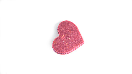 Raw heart shaped chocolate with dried fruits and nuts on a white background. High quality photo