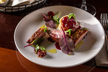 grilled pork tenderloin medallions served with mashed potato on wooden table