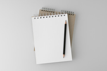 Open, office Notepad for notes on a spiral spring with a pencil on a gray background. School notebooks. Clean empty space, layout. Stylized stock photos. The view from the top. Mock-up.