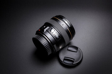 Lens for DSLR camera on black blackground.