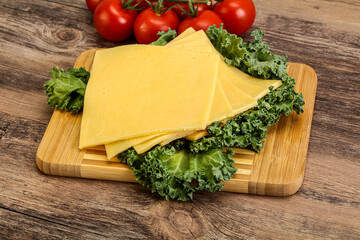 Sliced Gauda cheese over board
