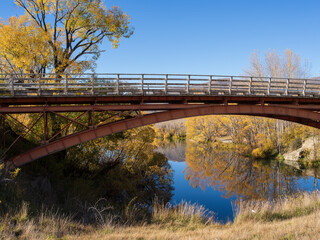 Red iron bridge in autumn, South Island, New Zealand.