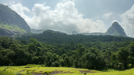 Panoramic view of lush green landscape with mountains near Devkund in Raigad, Maharashtra, India