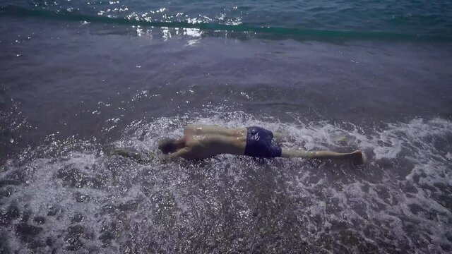 The body of an adult man who drowned at sea. Alcoholism on the water is very dangerous. The drowned man will be found by rescuers.