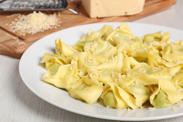 Tortellini stuffed with spinach and ricotta. Covered with grated cheese.