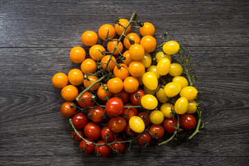Fresh Yellow Baby plum tomatoes, on branch.