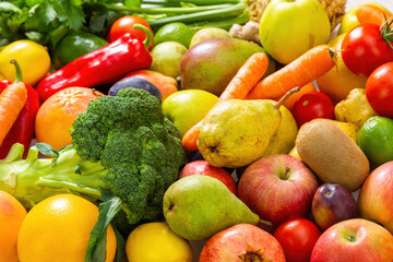 Assorted fresh raw fruit and vegetable in close up. Full frame of many healthy vegetarian food in detail. Group of colorful juicy vegan plants zoom in.