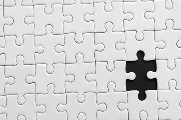 White jigsaw puzzle pattern background. placing last piece of jigsaw puzzle.