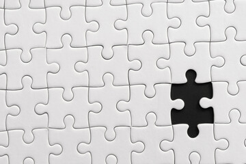 Fototapeta premium White jigsaw puzzle pattern background. placing last piece of jigsaw puzzle.